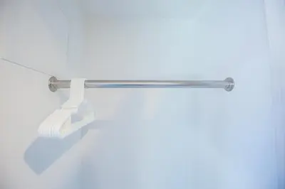 a metal towel rack with a white towel at Shinjuku Ryokan Retreat丶Local Tokyo Experience & Short Trips Hub丶walk to Shinjuku station EoE4 in Tokyo