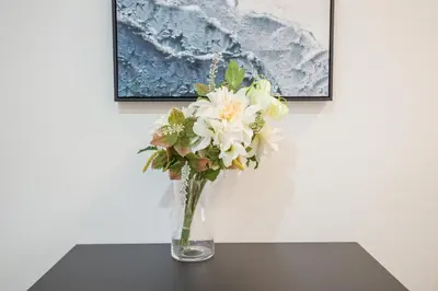 a vase filled with white flowers sitting on a table at Shinjuku Ryokan Retreat丶Local Tokyo Experience & Short Trips Hub丶walk to Shinjuku station EoE4 in Tokyo