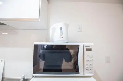 a white appliance sitting on top of a microwave at Shinjuku Ryokan Retreat丶Local Tokyo Experience & Short Trips Hub丶walk to Shinjuku station EoE4 in Tokyo