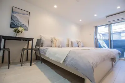 a bedroom with a bed and a table and a window at Shinjuku Ryokan Retreat丶Local Tokyo Experience & Short Trips Hub丶walk to Shinjuku station EoE4 in Tokyo