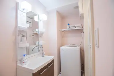 a bathroom with a sink and a toilet and a mirror at Shinjuku Ryokan Retreat丶Local Tokyo Experience & Short Trips Hub丶walk to Shinjuku station EoE4 in Tokyo