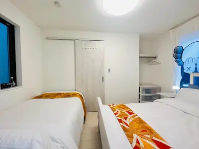 a bedroom with two beds and a window at Colorful House SKY TREE in Tokyo