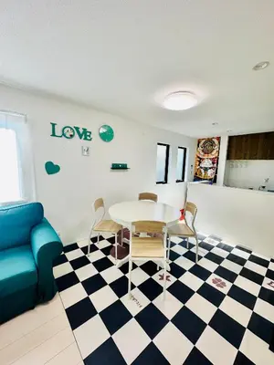 a living room with a table and a couch at Colorful House SKY TREE in Tokyo