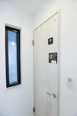 a door with a sign on it next to a window at Colorful House SKY TREE in Tokyo