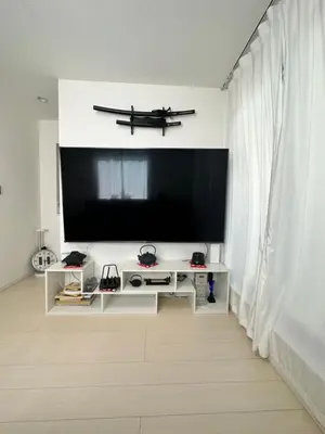 a living room with a flat screen tv on a wall at Colorful House SKY TREE in Tokyo
