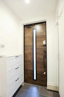a bathroom with a wooden door in a room at Colorful House SKY TREE in Tokyo