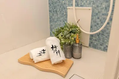 two towels with asian writing on them on a bathroom counter at \u685c\u306e\u5ddd12 \u6c60\u888b\u99c5 7\u5206 2-5\u4eba\u4e28Ikebukuro 7 minutes 2-5 people in Tokyo