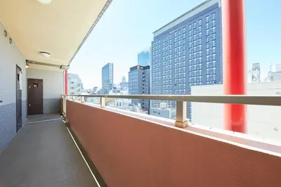 a balcony of a building with a view of a city at Shinjuku Kabukicho Designer's Apartment III in Tokyo