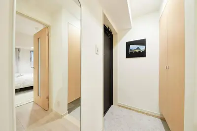 a hallway with a mirror and a bed in a room at Shinjuku Kabukicho Designer's Apartment III in Tokyo