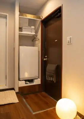 a door to a room with a television in a room at \u30a2\u30f3\u30c9\u30b9\u30c6\u30a4\u65b0\u5bbf7\u4e01\u76ee in Tokyo
