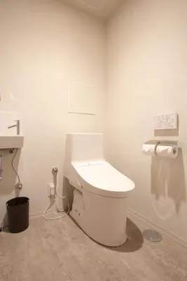 a bathroom with a white toilet in a room at OHWA hostel minowa station in Tokyo