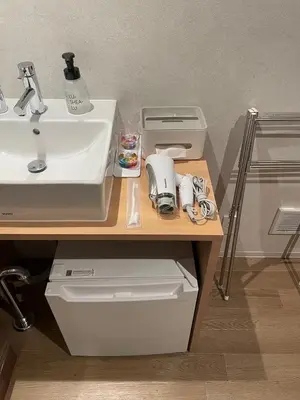 a bathroom with a sink and a counter with a sink at OHWA hostel minowa station in Tokyo