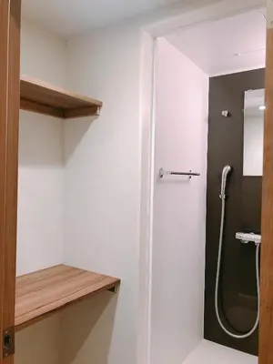 a bathroom with a shower stall and a toilet at OHWA hostel minowa station in Tokyo