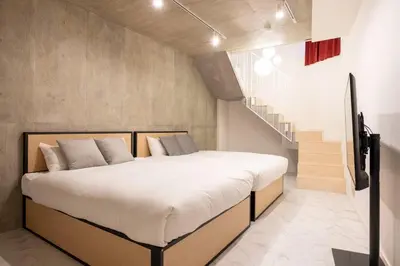 a bedroom with a large bed and a staircase at Lega land\u4e09\u8ed2\u8336\u5c4bANNEX in Tokyo