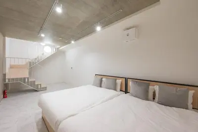 a bedroom with a large bed and a staircase at Lega land\u4e09\u8ed2\u8336\u5c4bANNEX in Tokyo