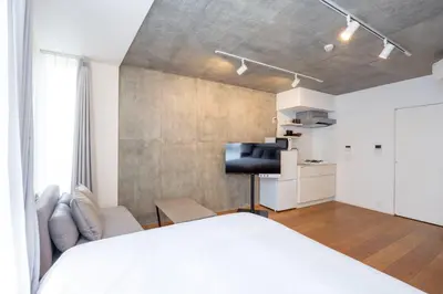 a bedroom with a bed and a desk in it at Lega land\u4e09\u8ed2\u8336\u5c4bANNEX in Tokyo