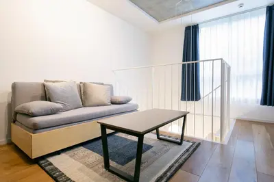 a living room with a couch and a table at Lega land\u4e09\u8ed2\u8336\u5c4bANNEX in Tokyo