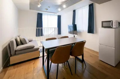 a living room with a table and chairs and a couch at Lega land\u4e09\u8ed2\u8336\u5c4bANNEX in Tokyo