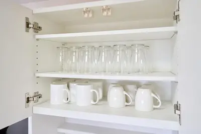 a cupboard filled with glass jars and mugs at K-Large balcony, Luxury 2Bedroom Condo, 101sqm,Max14 PPL,7mins walk to station, Elevator,QuiteArea in Tokyo