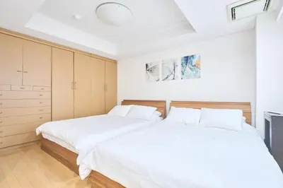 two beds in a bedroom with white sheets at K-Large balcony, Luxury 2Bedroom Condo, 101sqm,Max14 PPL,7mins walk to station, Elevator,QuiteArea in Tokyo