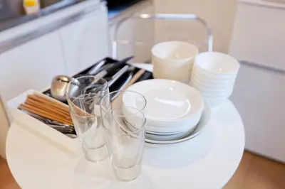 a counter with two glasses and plates and utensils at Mi-FUJITAKI WASEDA in Tokyo