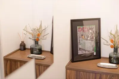 two wooden shelves with vases and a picture and a mirror at Mi-FUJITAKI WASEDA in Tokyo
