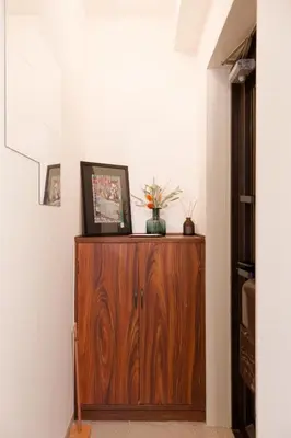 a room with a wooden cabinet with flowers on it at Mi-FUJITAKI WASEDA in Tokyo