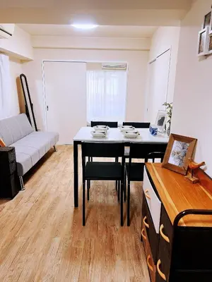 a living room with a table and a couch at 交通便利 山手線池袋駅 徒歩6分 東池袋駅徒歩3分 2~5人 エレベーター WIFI 新宿/渋谷/銀座/築地/浅草/原宿近い！ in Tokyo