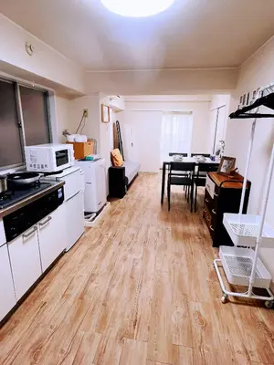 a kitchen with white cabinets and a table in it at 交通便利 山手線池袋駅 徒歩6分 東池袋駅徒歩3分 2~5人 エレベーター WIFI 新宿/渋谷/銀座/築地/浅草/原宿近い！ in Tokyo