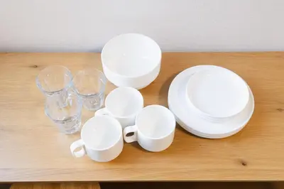 a group of white plates and glasses on a table at East Court Nagasaki - Vacation STAY 8634 in Tokyo