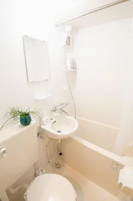 a white bathroom with a toilet and a sink at East Court Nagasaki - Vacation STAY 8634 in Tokyo