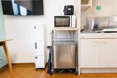a kitchen with a cart with a microwave on it at East Court Nagasaki - Vacation STAY 8634 in Tokyo
