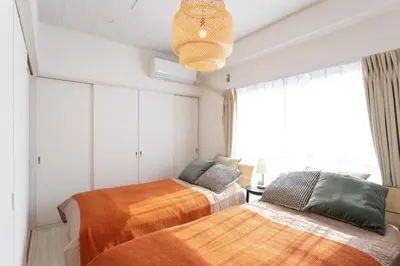 two beds in a room with a window at 