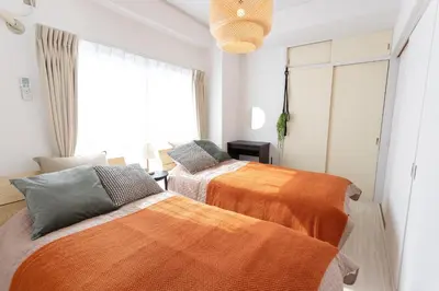 two beds in a room with a window at 