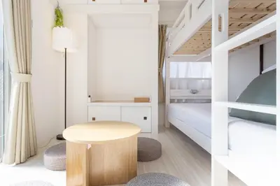 a small bedroom with a bed and a table and chairs at 