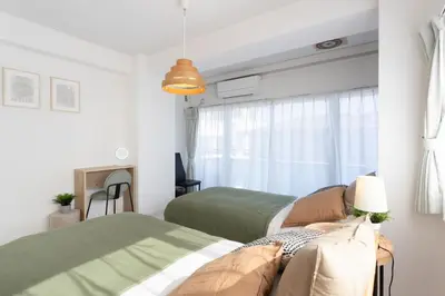 a bedroom with two beds and a window at 