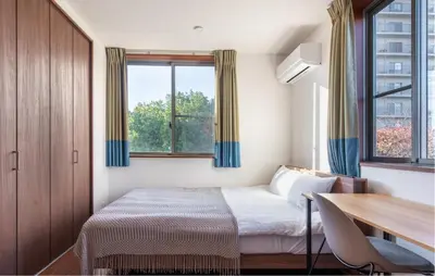 a bedroom with a bed and a desk and a window at Residential Voyan Minamisunacho - Vacation STAY 14988v in Tokyo