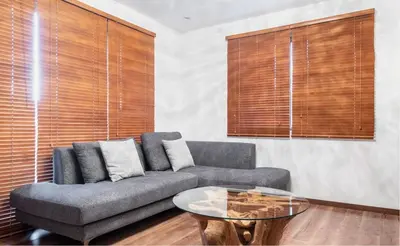 a living room with a couch and a glass table at Residential Voyan Minamisunacho - Vacation STAY 14988v in Tokyo