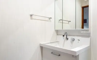 a white bathroom with a sink and a mirror at Residential Voyan Minamisunacho - Vacation STAY 14988v in Tokyo