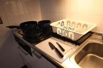 a kitchen stove with two pots and pans on it at \u5357\u6c60\u888b\u6238\u5efa in Tokyo