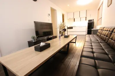 a living room with a couch and a table at \u5357\u6c60\u888b\u6238\u5efa in Tokyo