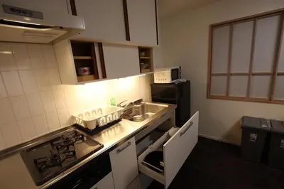 a small kitchen with a sink and a stove at \u5357\u6c60\u888b\u6238\u5efa in Tokyo