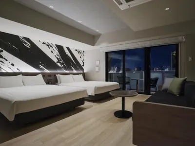 a hotel room with two beds and a couch at MONday Apart Premium Asakusa in Tokyo