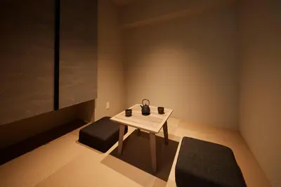 a small table and two stools in a room at MONday Apart Premium Asakusa in Tokyo