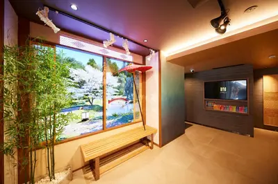 a room with a large window and a plant at MONday Apart Premium Asakusa in Tokyo