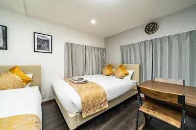 a hotel room with two beds and a table at 87, Senzoku, Detached house for rent, \u5343\u675f in Tokyo