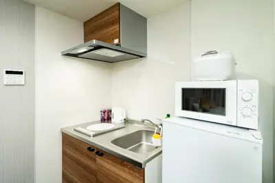 a small kitchen with a sink and a microwave at 87, Senzoku, Detached house for rent, \u5343\u675f in Tokyo