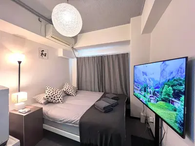 a room with a bed and a large screen tv at JUN shinjuku408-SJ0099 in Tokyo