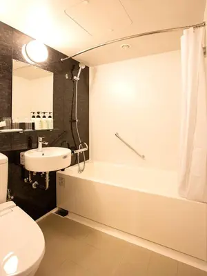 a bathroom with a tub and a toilet and a sink at Ryogoku View Hotel in Tokyo