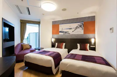 a hotel room with two beds and a couch at Ryogoku View Hotel in Tokyo